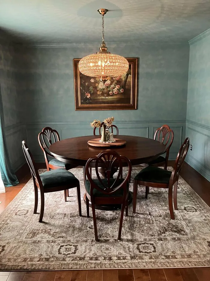 Elegant dining room with dark wood furniture, a crystal chandelier, and classic home decoration proudly shared online.