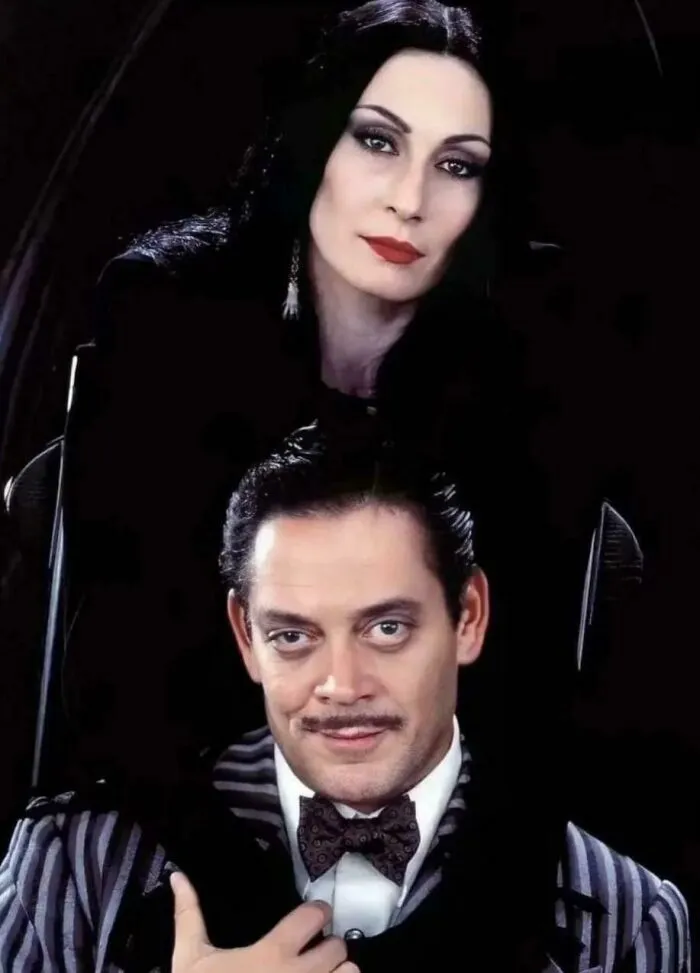 90s nostalgic Addams Family portrait with Morticia and Gomez Addams