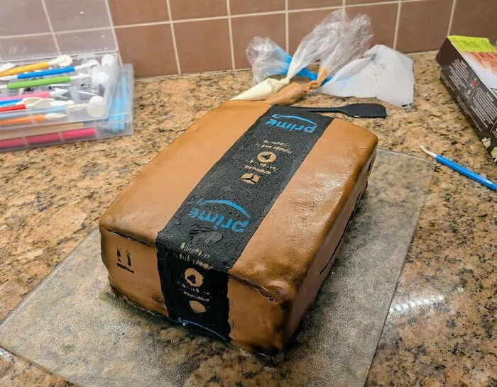 Realistic baked goods shaped like an Amazon package, showcasing gorgeous baked goods magic in the kitchen.