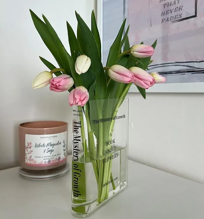 Turning Their Stack Of Beloved Books Into An Unexpected, Minimalist Floral Display Is A Chic Way To De-Stress With A <a Style="Display:inline;" Href="Https://Www.amazon.com/Puransen-Bookend-Vase-Flowers-Minimalist/Dp/B099pqb6tz?ie=utf8&th=1&linkcode=ll1&tag=bpcheetah-20&linkid=96525b378b0a892b594737f6c13040b2&language=en_us&ref_=as_li_ss_tl" Target="_blank">  <span Style="Font: Inherit; Color: #d74b1f;"> Clear Book Vase</Span>
