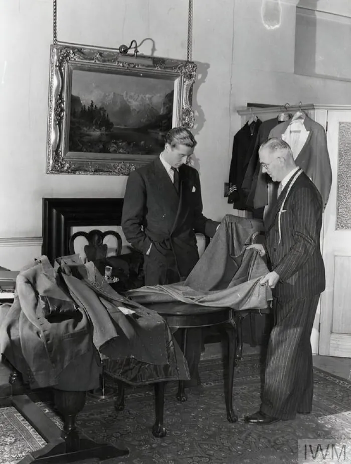 The Master Tailor At This Tailoring Firm (Probably Anderson's On Savile Row) Helps A Customer To Select Cloth For His Suit