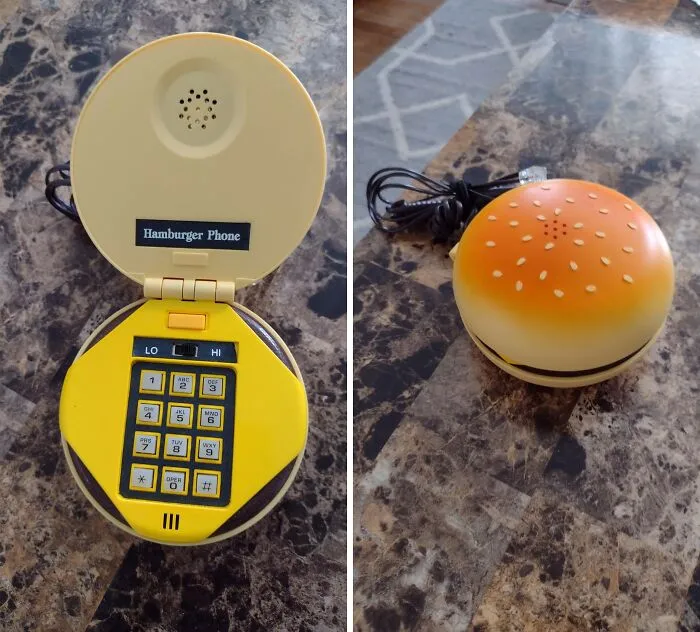 Retro hamburger-shaped novelty phone thrift store find shown closed and open with yellow keypad on marble surface.