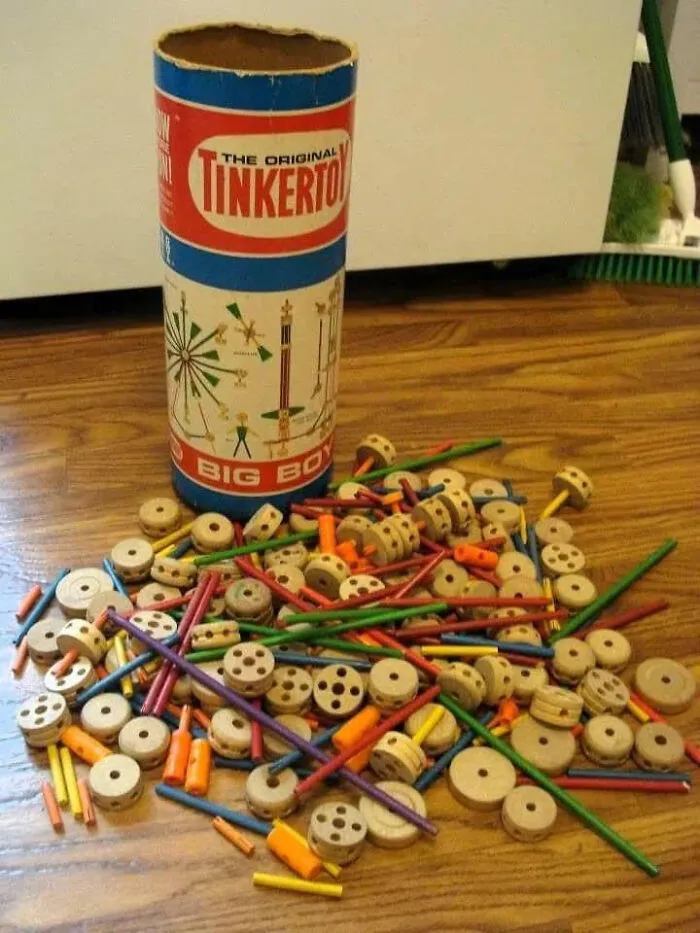 Vintage Tinkertoy construction set with wooden spools and colorful sticks evoking nostalgia and old age memories