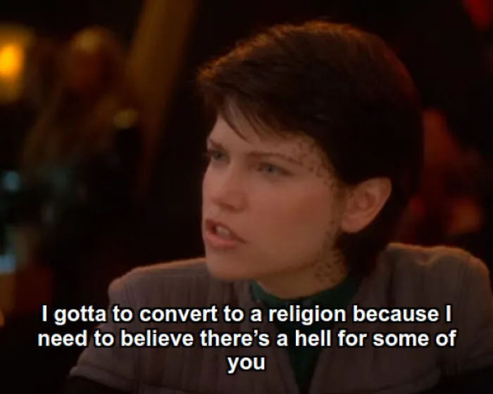 Woman with spotted facial makeup in costume saying a funny random post about converting to a religion and hell.