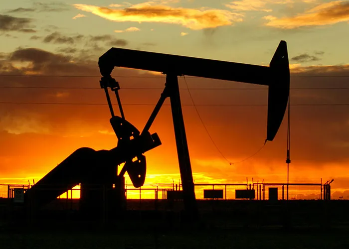 Silhouette of oil rig pump at sunset representing jobs that only a person without a soul would do in harsh conditions