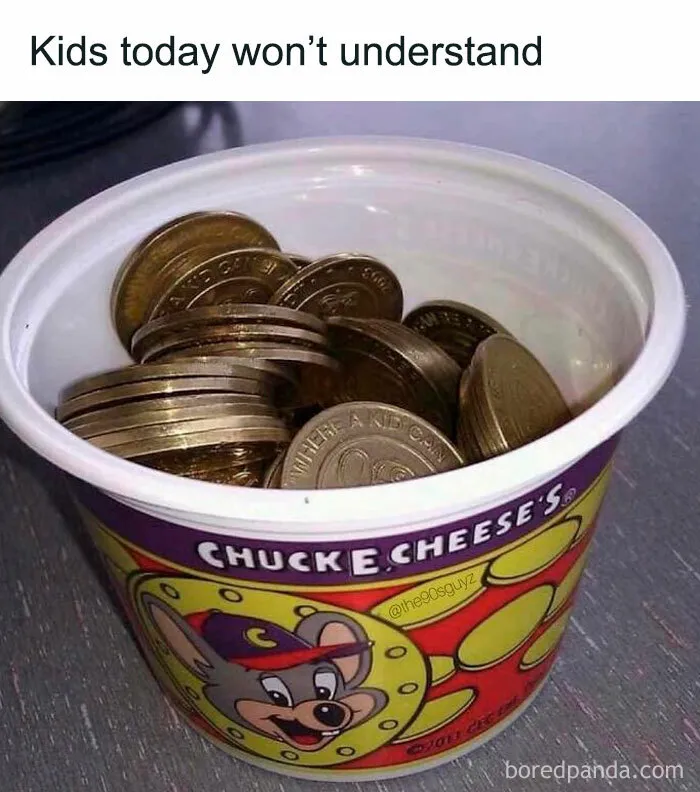 Plastic cup filled with Chuck E. Cheese tokens, representing 90s nostalgia and nostalgic childhood memories.