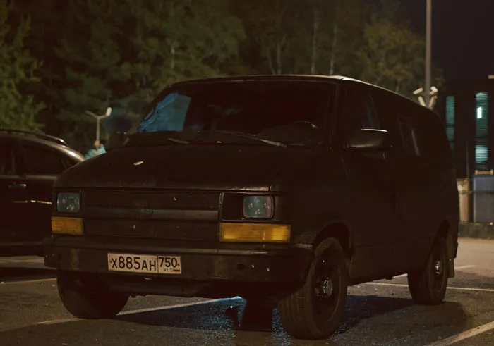Dark van parked at night under streetlights, illustrating unusual scenes caught on security camera footage.