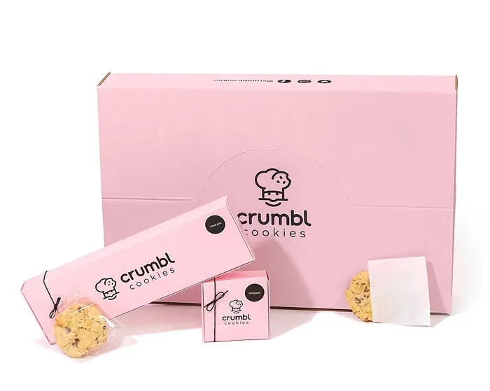 Pink Crumbl Cookies packaging with wrapped cookies, showcasing a stylish family flex of gourmet treats.