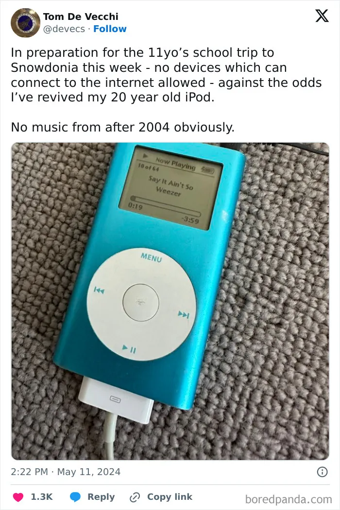 Vintage blue iPod playing music on a textured carpet, representing chaotic British memes nostalgia from the U.K. culture.