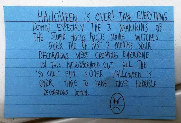 Handwritten note from a neighbor demanding Halloween decorations be taken down, showcasing unhinged neighbor notes.