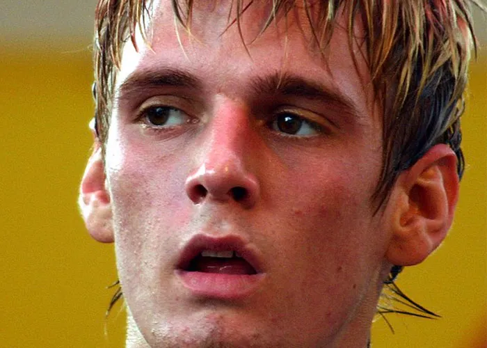 Close-up of a young man with wet hair, captured during an intense moment, fitting a total gentleman encounter theme.