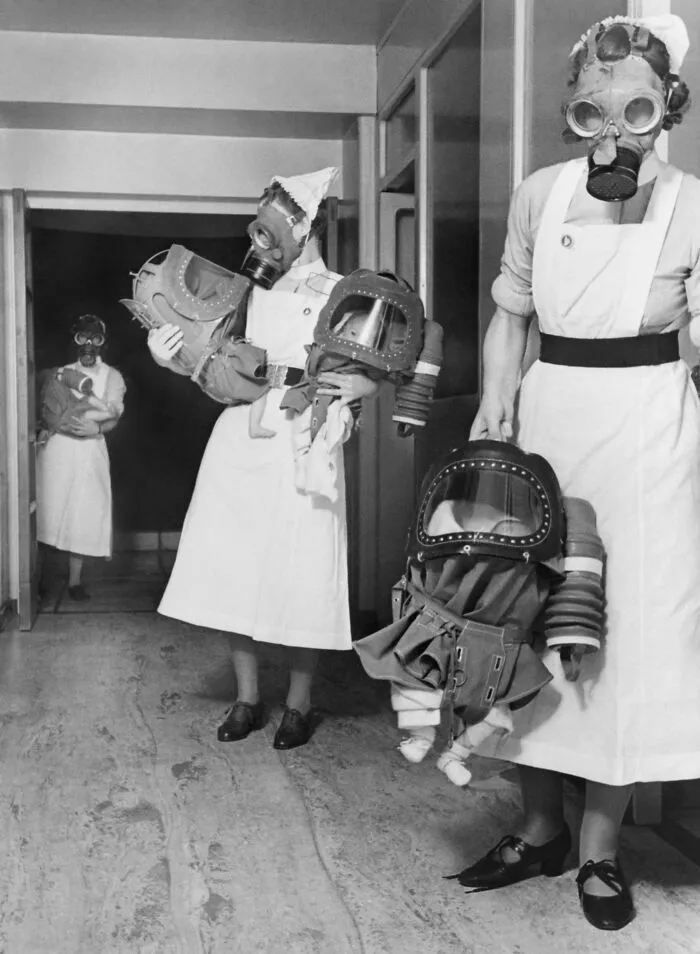  Nurses Carrying Babies During A Gas Drill In 1940