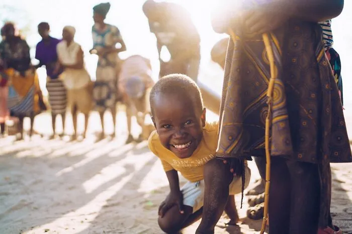 Visiting The Local Okavango Delta Village, Singing, Dancing, And Playing Football With The Kids