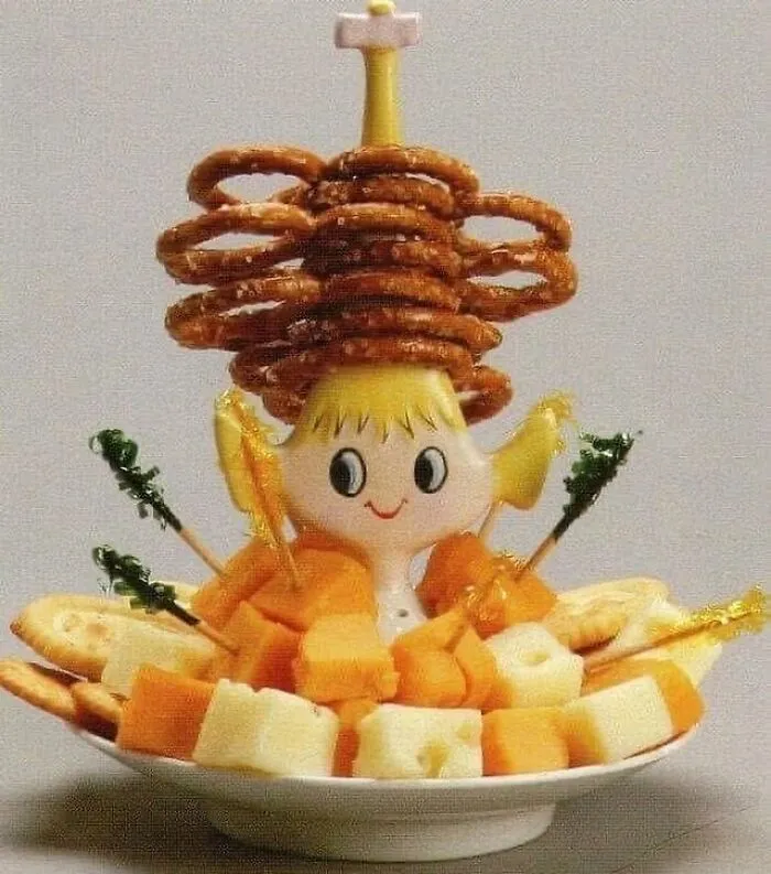 Vintage cheese and pretzel snack with a whimsical June Cleavers vintage closet figurine centerpiece.
