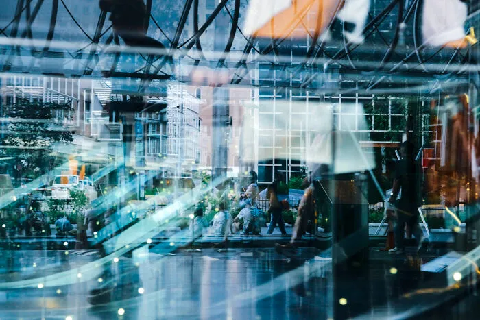 City street scene reflected in glass, showcasing poetic and cinematic photography capturing ordinary moments in an urban setting.