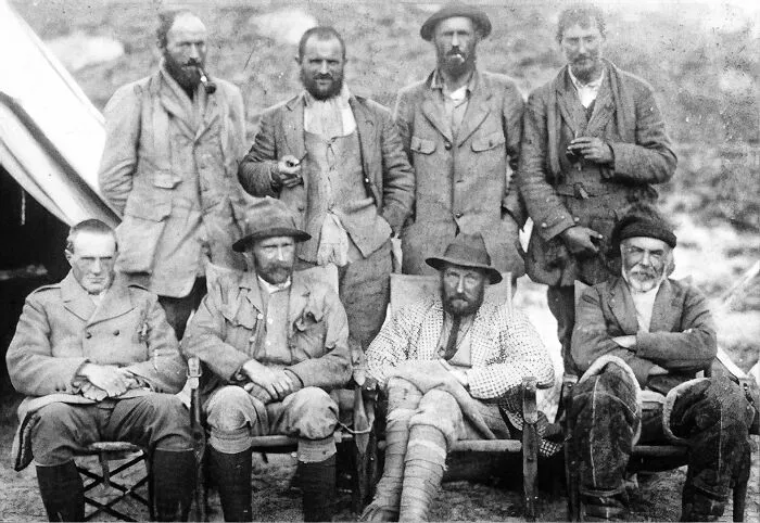 Group of early 20th century explorers posing outdoors, linked to world’s greatest unsolved mysteries that still baffle people.
