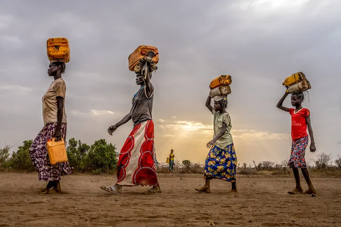 Women Of The Kangaten Tribe Carrying Water To Their Homes, Omo Valley, Ethiopia