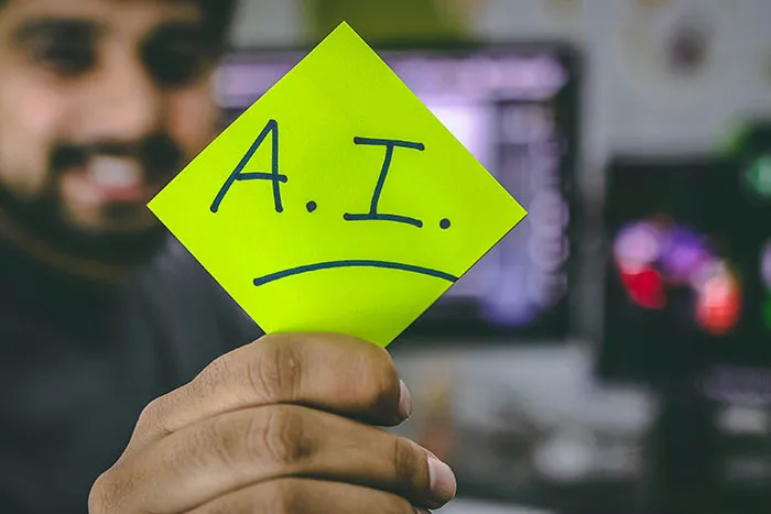 Person holding a yellow sticky note with A.I. written on it, relating to hot take and boomers discussion.