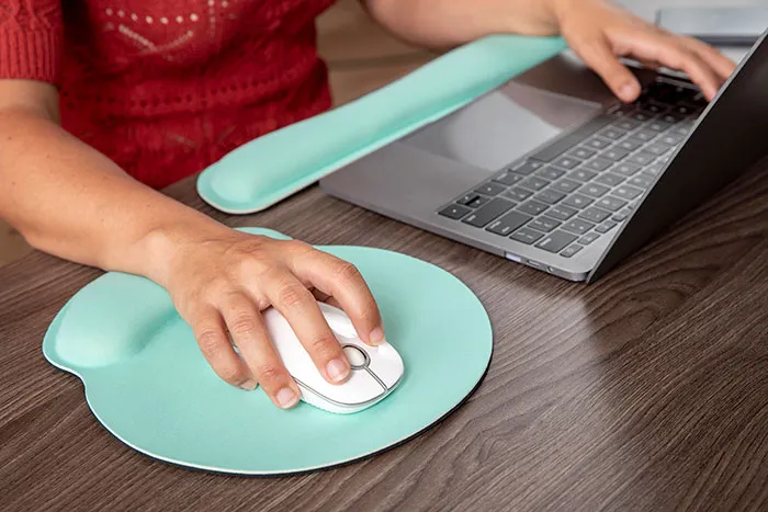 Person using laptop and mouse with ergonomic mouse pad, illustrating hot take discussion with boomers concept