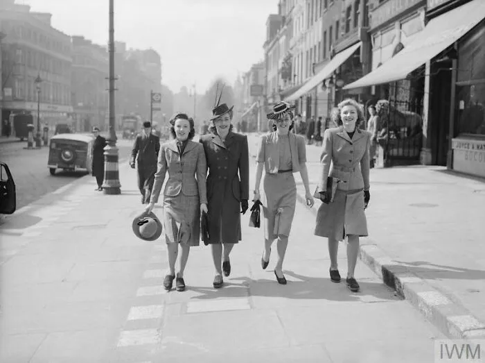 Four Young Ladies Enjoy A Stroll In The Spring Sunshine Along A Shopping Street In The West End Of London