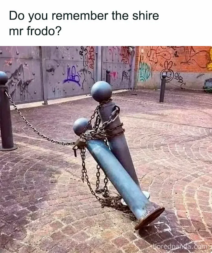 Metal bollards chained and leaning, resembling two figures, with graffiti background, related to Lord of the Rings memes.