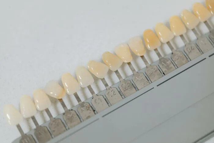 Dental shade guide showing different tooth colors used in cosmetic dentistry for matching natural teeth shades.