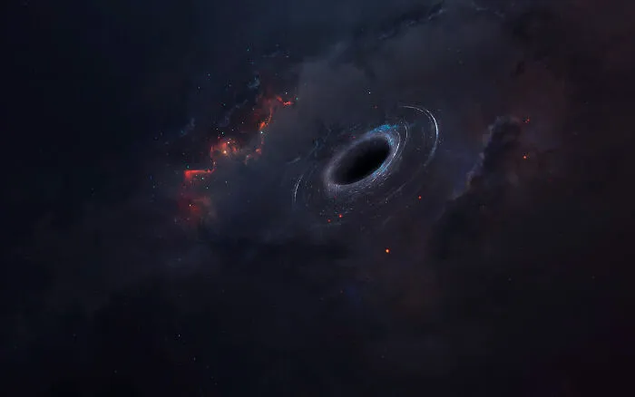 Dark space scene featuring a swirling black hole surrounded by glowing cosmic dust and distant stars, showing space's scary vastness.