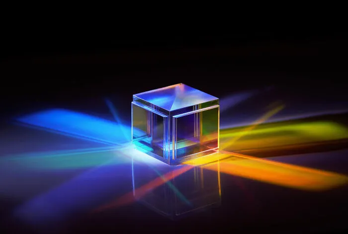 Transparent glass cube refracting colorful light beams, illustrating how space is a lot scarier than we think concept.