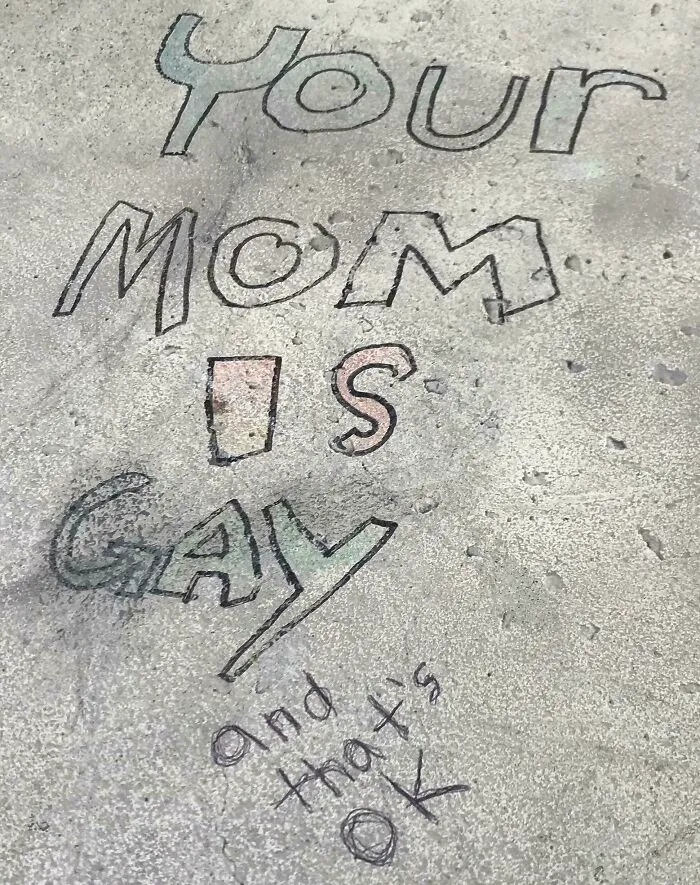 Graffiti vandalism on a concrete surface with playful and colorful text as public property art.