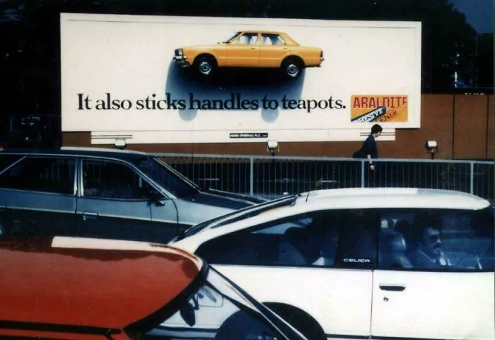 Creative billboard design with a car stuck on it, showcasing smart and cool design innovation by designers.