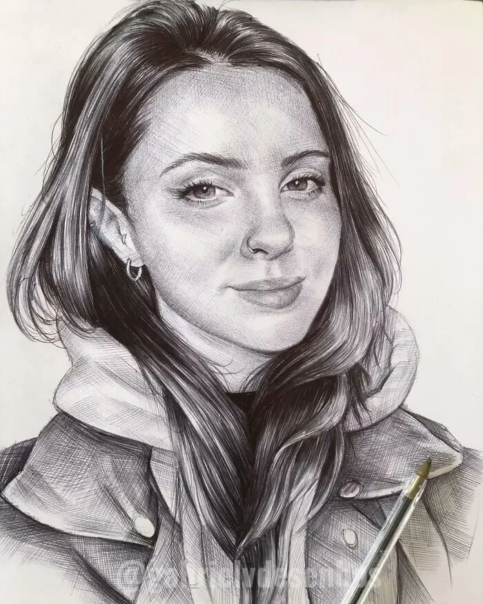 Realistic portrait of a young woman created with a ballpoint pen, showcasing detailed shading and lifelike features.