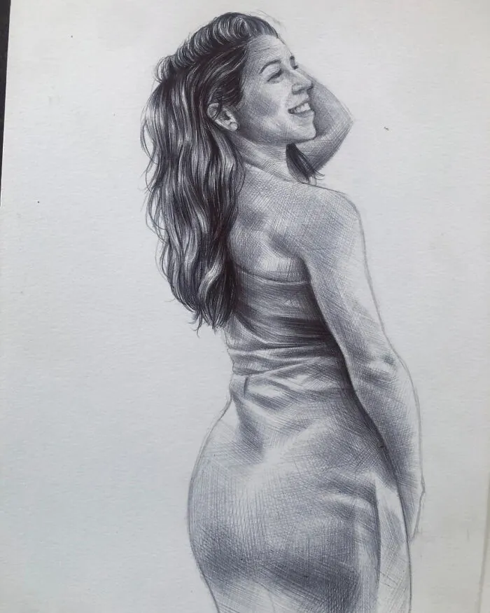 Realistic portrait of a smiling woman with flowing hair created using only a ballpoint pen drawing technique.