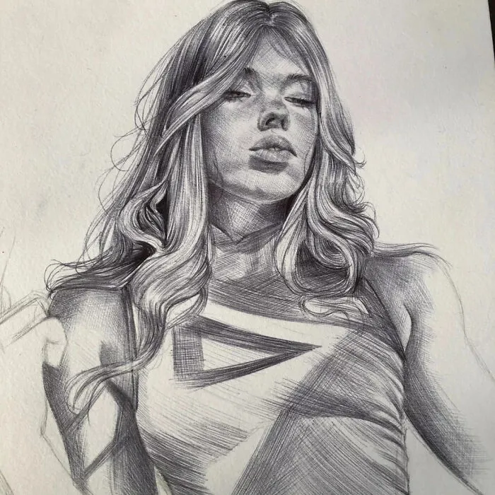 Ballpoint pen portrait of a woman with flowing hair, showcasing detailed shading that makes it look photographed.