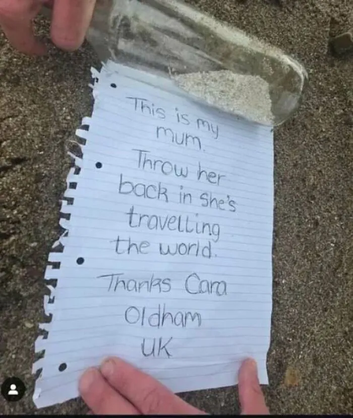 Message in a bottle on sand with handwritten note asking to throw it back for heartwarming stories to cleanse negativity.