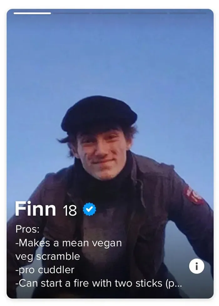 Young man with a black hat smiling in a Tinder profile showcasing creative Tinder bios for guys to attract matches.