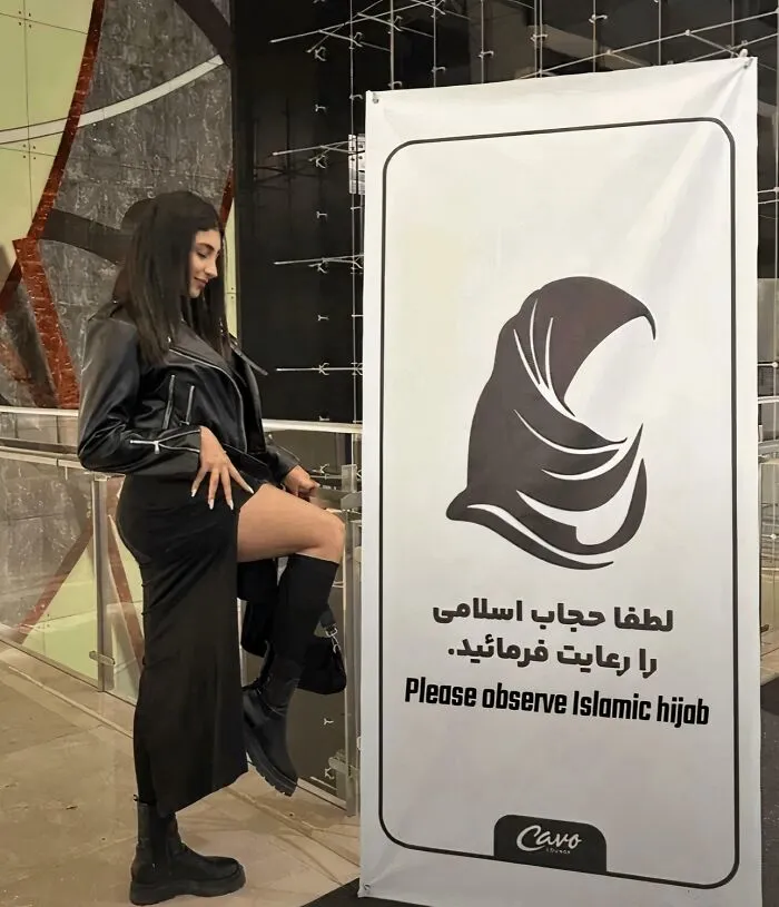 Mujeres iraníes delante de un cartel sobre el hiyab