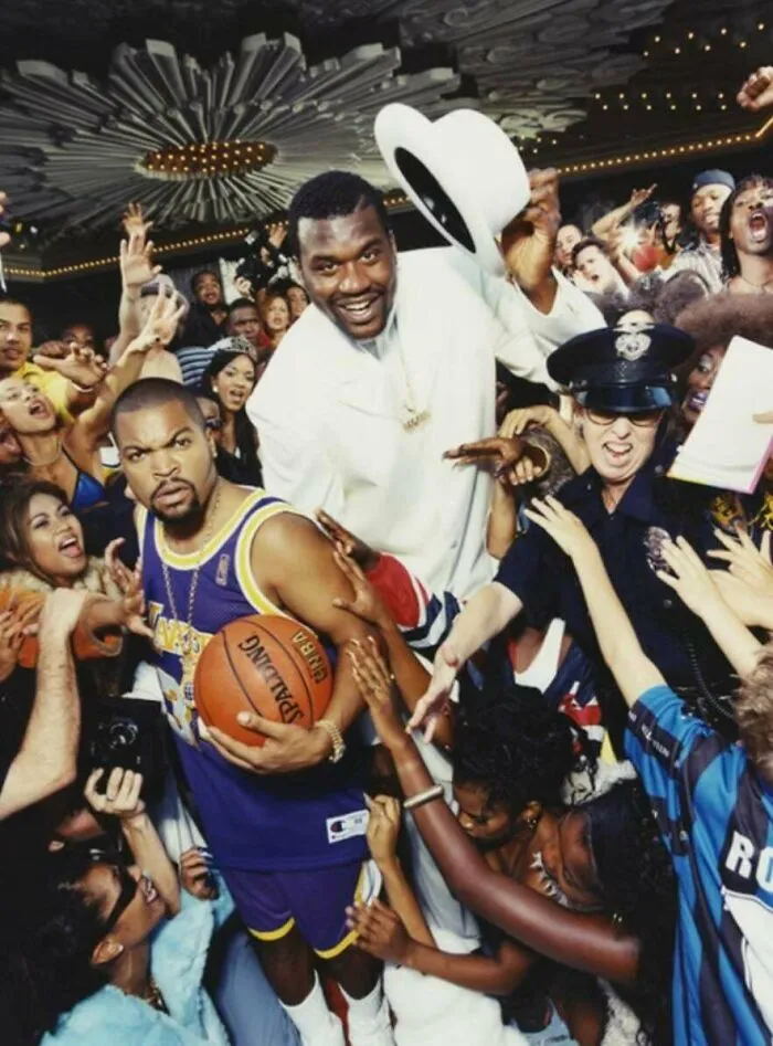 Crowded 90s party scene with basketball player and man in white suit, capturing funny 90s posts and memes nostalgia.