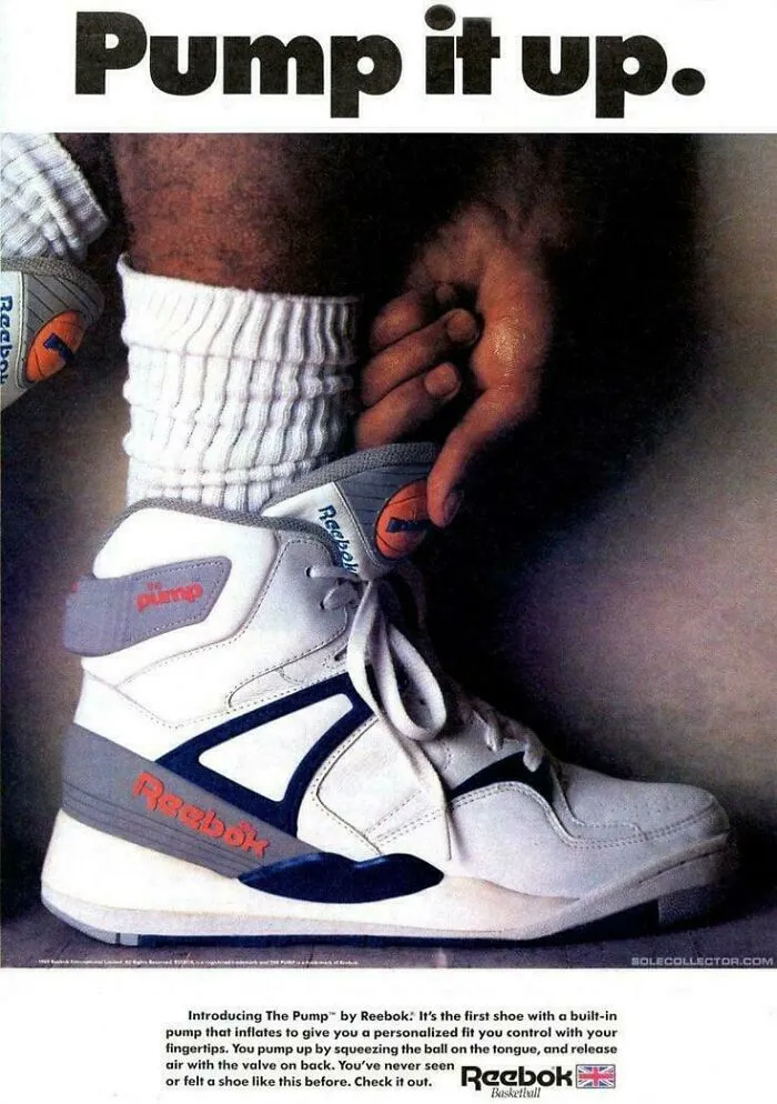 Close-up of a person inflating a classic 90s Reebok Pump sneaker, evoking funny 90s childhood memories.