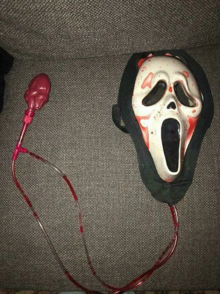 Vintage ’90s scream mask with blood bag Halloween prop, evoking funny ’90s childhood memories and nostalgia.