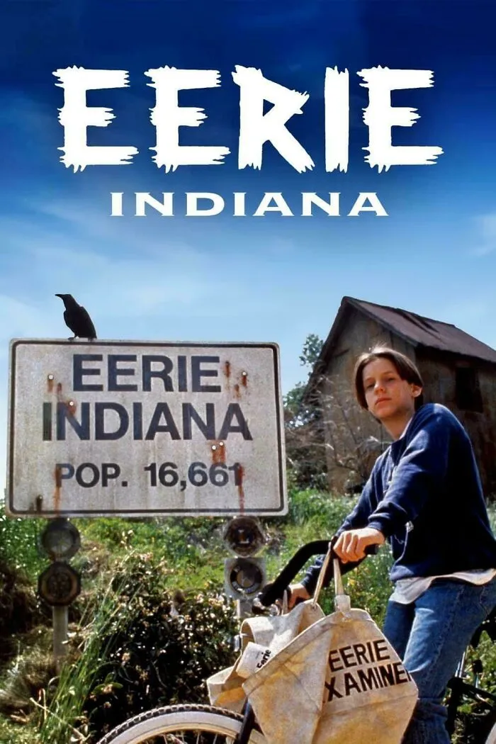 Boy on bike with Eerie Indiana town sign, capturing nostalgic ’90s posts and memes from childhood memories.