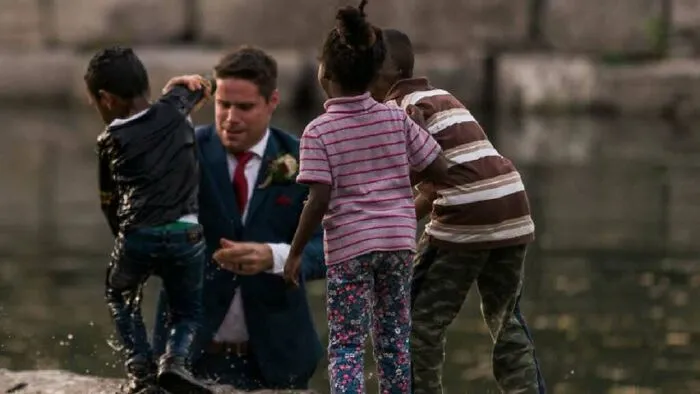 This Groom Was Having A Wedding Photoshoot With His Wife When He Noticed A Child Being Pushed By Another Child, Into A Nearby River