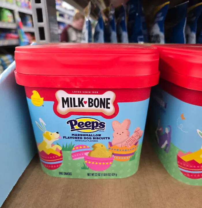 Milk Bone Peeps marshmallow flavored dog biscuits with colorful Easter-themed packaging on a store shelf.