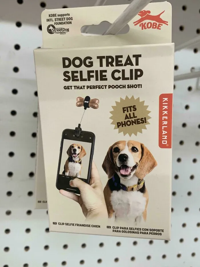 Dog treat selfie clip for perfect pooch photos, fitting all phones, showcased on retail packaging with dog image.