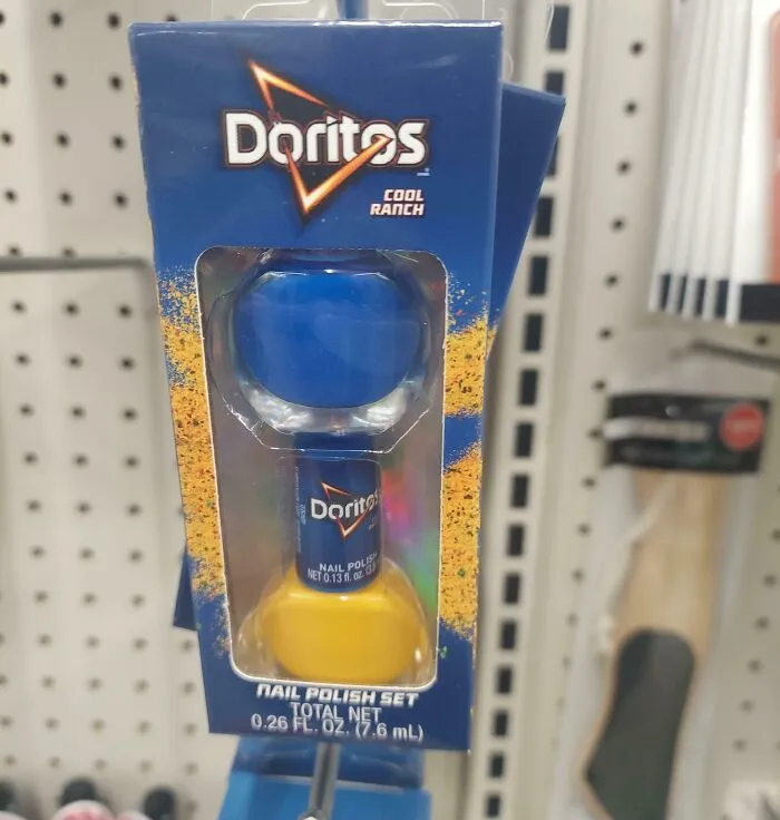 Doritos Cool Ranch nail polish set displayed on store shelf, featuring blue and yellow polish in branded packaging.