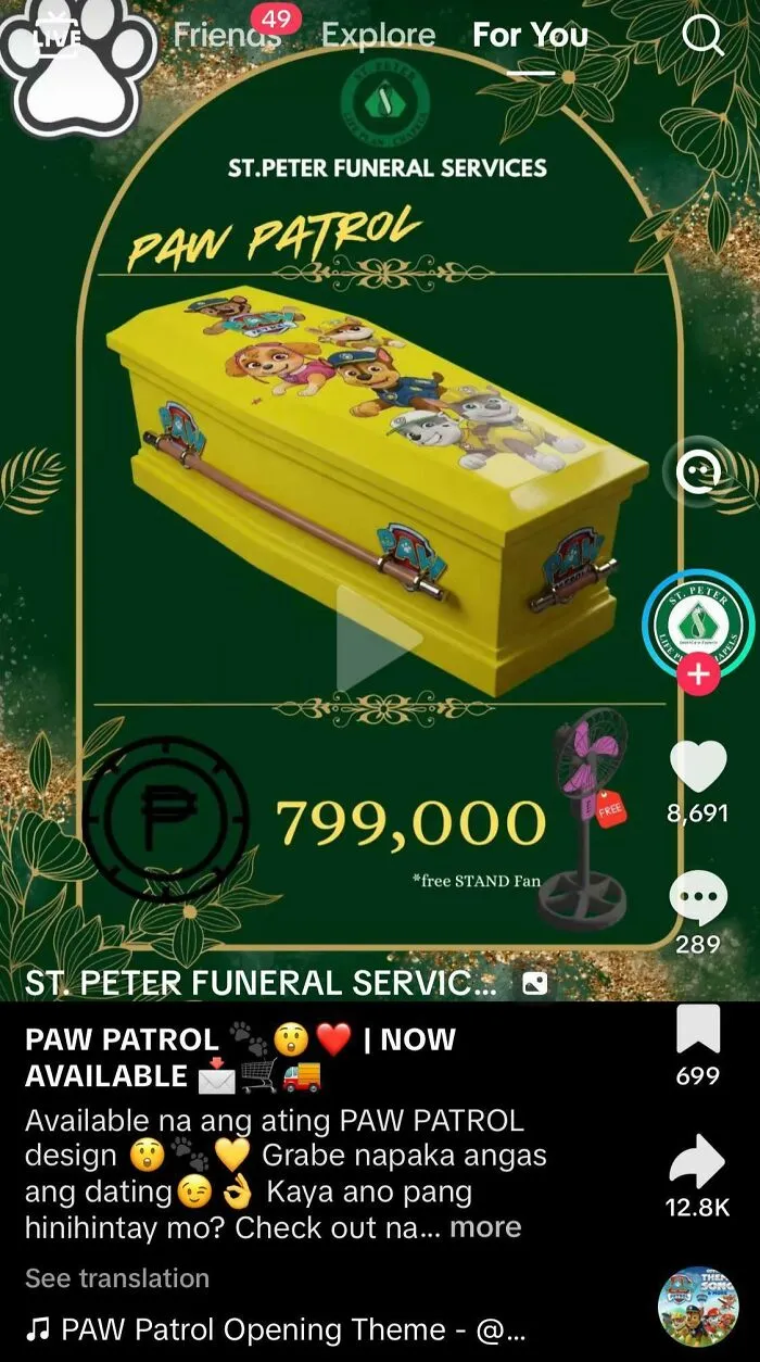 Bright yellow Paw Patrol themed coffin with cartoon characters, highlighting one of the most nonsensical things that actually exist.