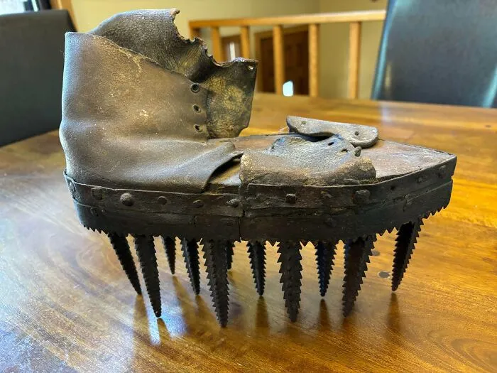 Old Leather Boot With Long Metal Spikes. Leather Is Old And Stiff, Sole Is Wood, Metal With Nails Or Rivets Around The Sole, 4” Spikes. Seems Like It Might Be A Mountaineering Boot