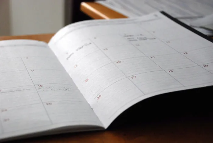 Open calendar planner on wooden table illustrating unexpected things men didn’t know about women until dating them