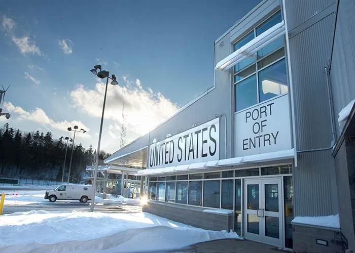 Snow-covered United States port of entry building with clear sky, illustrating criminal fails at border crossings.