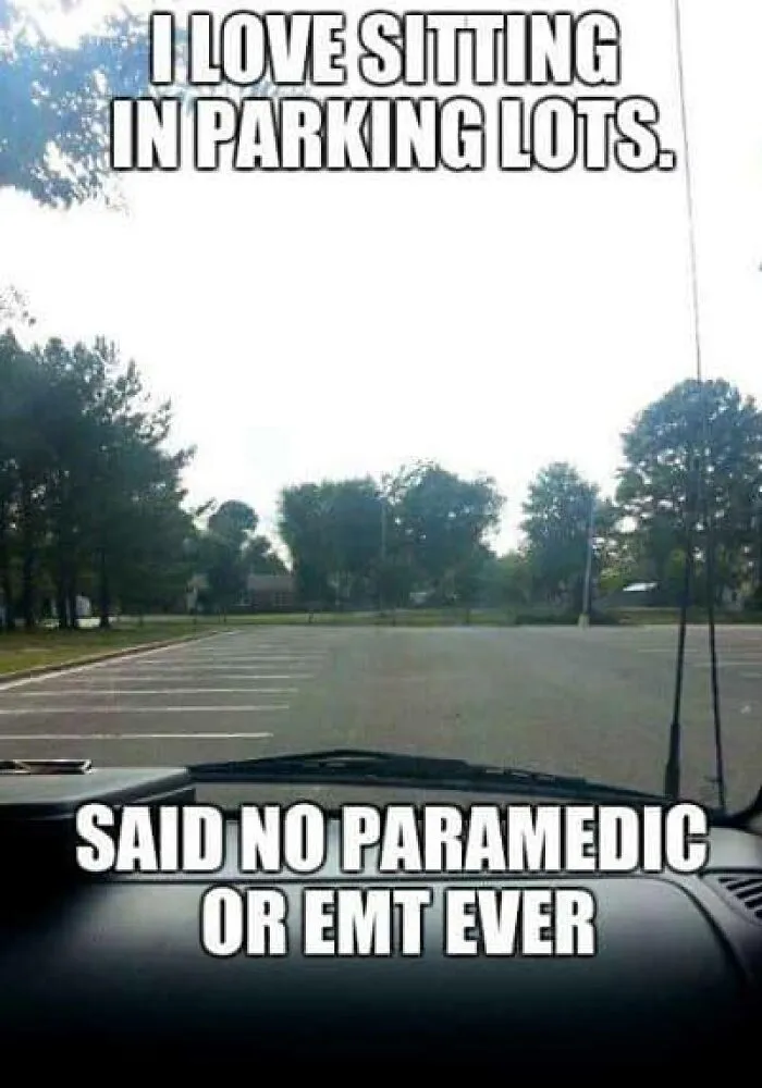 Empty parking lot viewed from inside an ambulance with text about EMT and paramedic humor and parking lots.