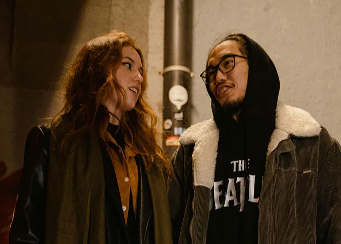 Two people having a casual conversation outdoors at night, illustrating coincidences that are incredible but true.
